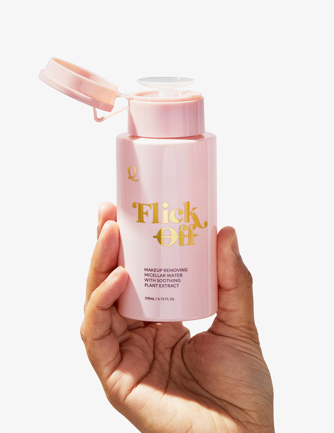 Hand holding Flick Off! Cleanser and Makeup Remover.